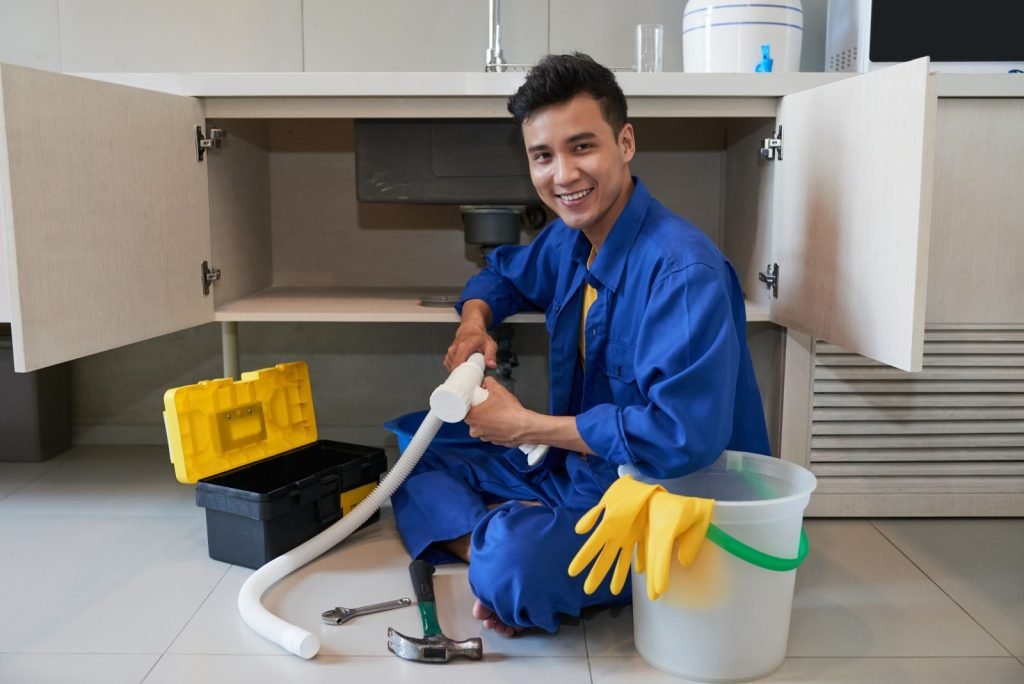 Plumber repairing a kitchen sink